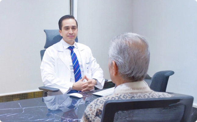 Dr. Ernesto Grimaldo speaking with a patient